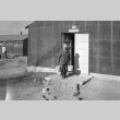 Man leaving Laundry #14 with two buckets (ddr-fom-1-416)