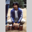Dale Sakai with cans of coffee (ddr-densho-336-787)