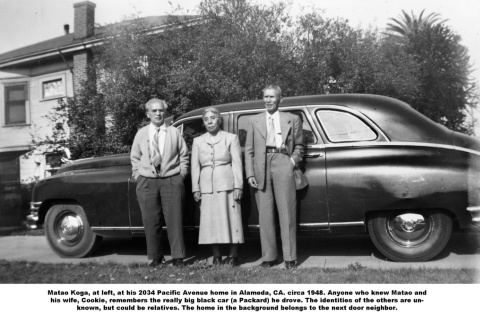 Three people standing next to car outside house (ddr-ajah-6-178)