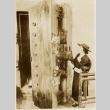 A woman standing next to a museum piece (ddr-njpa-1-1556)