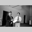 Two men leafing through papers (ddr-densho-1007-554)