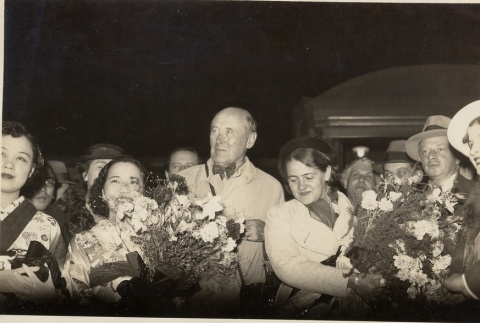 A group of people outside with bouquets (ddr-njpa-1-2574)