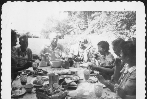 Group eating around a table outside (ddr-densho-434-410)