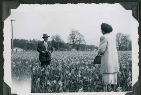 Nisei couple in field of daffodils (ddr-densho-359-443)