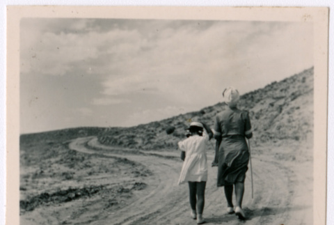 Japanese American woman and girl walk into the distance (ddr-densho-362-43)