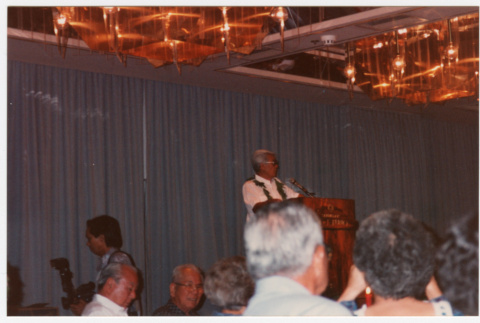 Man speaking at podium (ddr-densho-368-382)