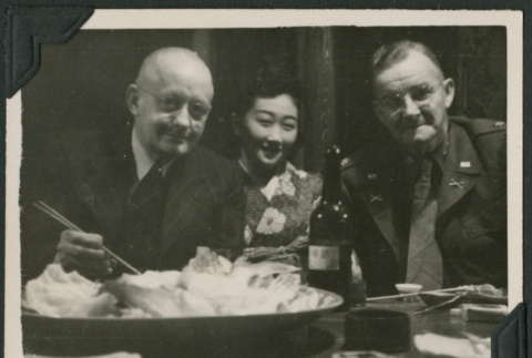 Two American men pose with a Japanese woman (ddr-densho-397-174)