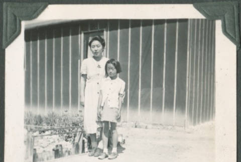 Woman with little girl by camp garden plot (ddr-densho-321-81)