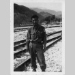 [Man in military uniform on railroad tracks] (ddr-csujad-1-23)