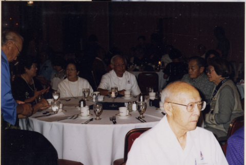 Group sitting around banquet table (ddr-densho-466-565)