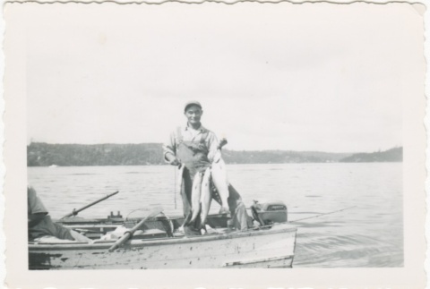 Man in boat with fish (ddr-densho-326-2)