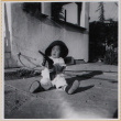 Susan Shiomi playing with toy gun (ddr-densho-522-269)