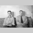 Two men seated on a couch (ddr-fom-1-382)