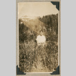 George Tokuda standing in tall grass (ddr-densho-383-273)