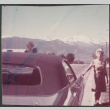 Agnes Sakura standing next to car with ragtop (ddr-densho-523-608)