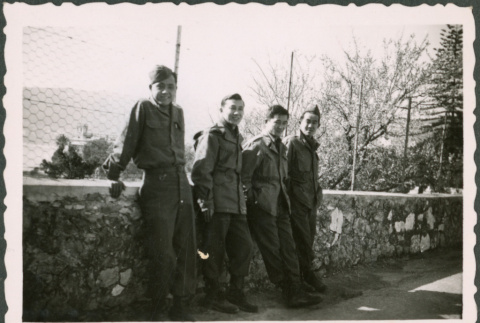 Four Soldiers leaning against a wall (ddr-densho-368-539)