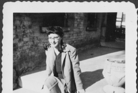 Woman in saddle shoes sitting on steps (ddr-densho-434-447)