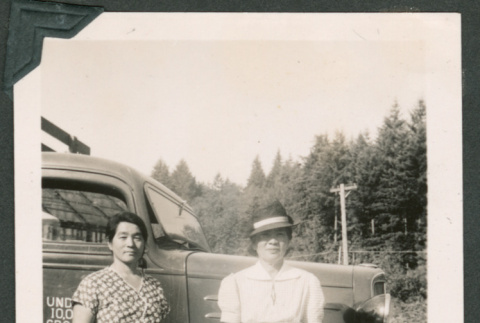 Photo of two women beside a truck (ddr-densho-483-369)