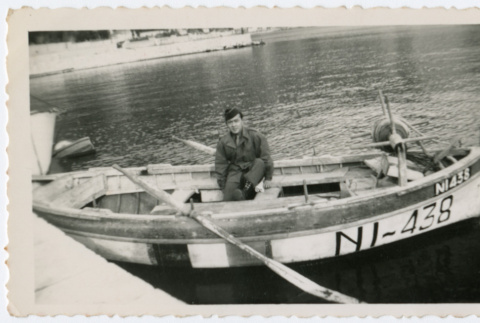 Two soldiers in rowboat on water (ddr-densho-368-221)