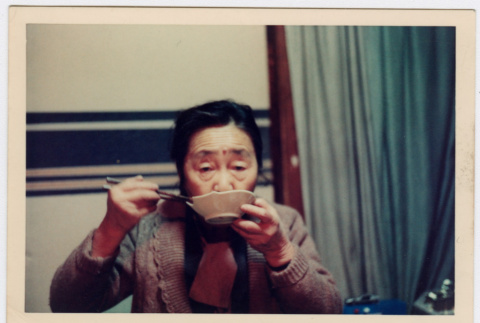 Woman sipping out of a bowl (ddr-densho-348-22)