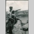 Two boys sitting on rocky overlook (ddr-densho-523-243)