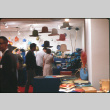 Group of people by hat and placemat display (ddr-densho-426-369)