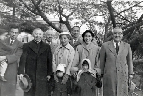 Five men, two women and three children standing outside by tree (ddr-densho-474-214)