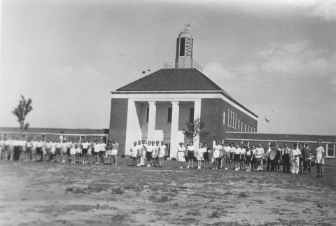 Ball teams and band in front of buildings (ddr-densho-115-5)