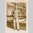 Man standing by railing of large building (ddr-densho-426-2042)