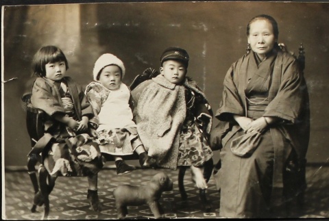 Grandmother and grandchildren on a settee (ddr-densho-259-47)