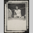 Sadako seated in the grass (ddr-densho-542-372)