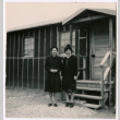 Two Japanese American women at barracks steps (ddr-densho-362-55)