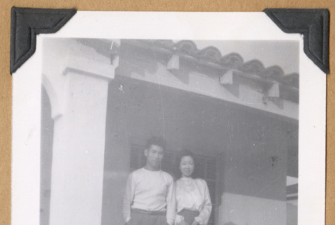 Four people posing on a porch (ddr-densho-542-310)