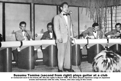 Susumu Tomine playing guitar with a band (ddr-ajah-6-955)