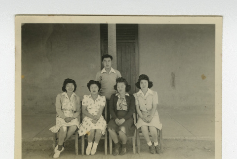Nisei women and man in front of barrack (ddr-csujad-44-18)