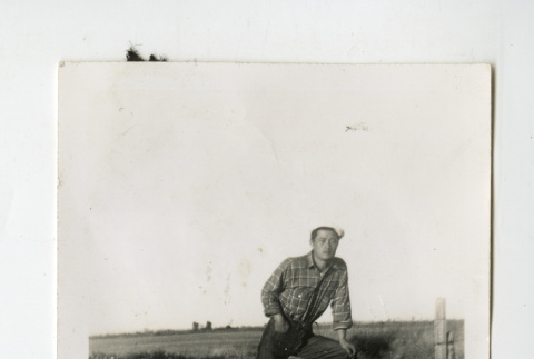 Nisei man standing on a bank (ddr-csujad-38-64)