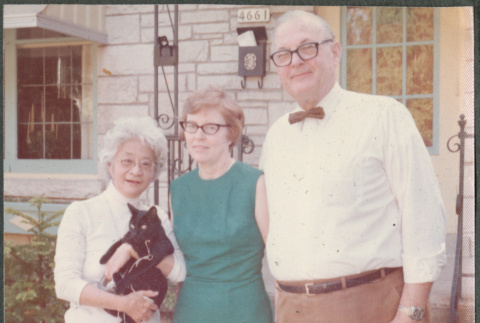 Man and two women, one holding car (ddr-densho-523-651)