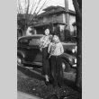 Sister and brother in front of car (ddr-densho-129-2)