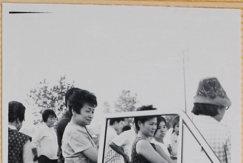Women standing by open car door (ddr-densho-522-99)
