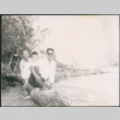 Chester Sakura Sr., with man and woman sitting on log (ddr-densho-523-335)