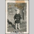 Toddler in coat and hat standing on gravel street (ddr-densho-483-696)