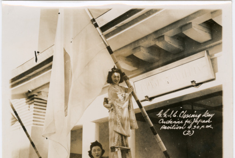Two women on ladder with large flag (ddr-densho-426-2094)