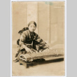 Woman playing instrument (ddr-densho-359-205)
