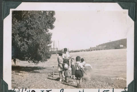 Photo of a man with a group of children (ddr-densho-483-904)