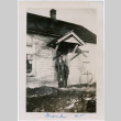 Man poses in front of home (ddr-densho-363-62)