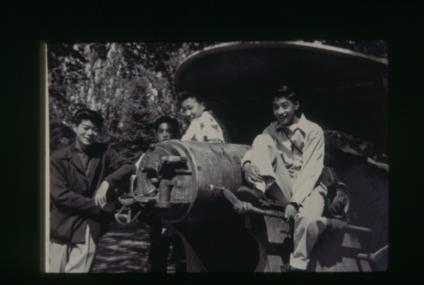 (Slide) - Image of group of young men sitting on field gun (ddr-densho-330-221-master-f5ca1cafac)