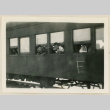 Young men looking out from a train car (ddr-densho-37-916)