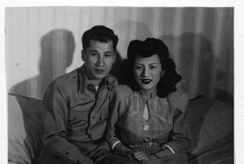Pair sitting on couch (ddr-densho-1007-54)