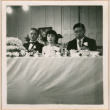 Tomoyuki Nozawa (right) with unidentified man and woman seated at head table (ddr-densho-410-496)