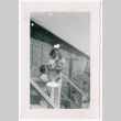 Photo of a woman with two children outside a barrack (ddr-densho-483-41)